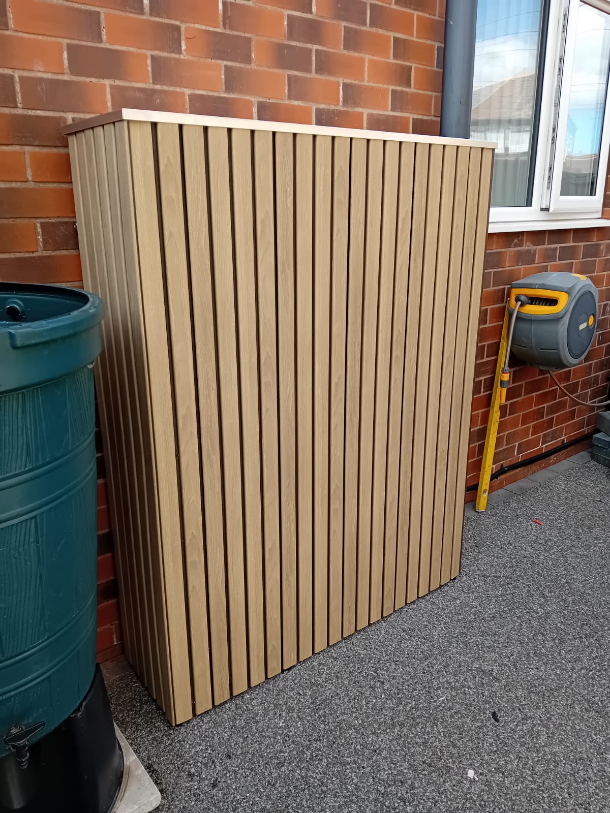 SigEnergy solar battery cover in Oak finish — installed and fitted — SolarBatteryCovers.ie