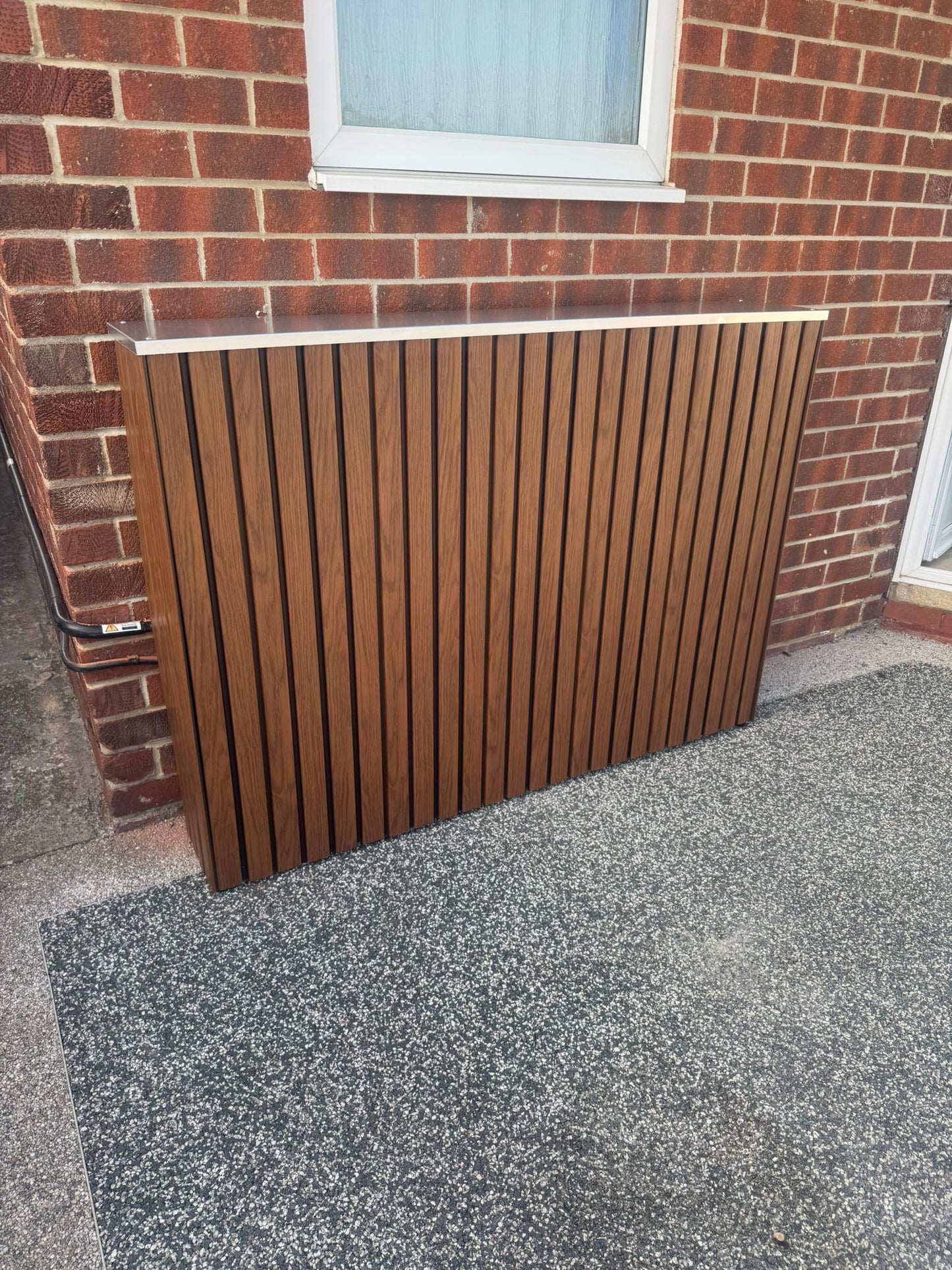 Sunsynk solar battery cover in Walnut finish — installed and fitted — SolarBatteryCovers.ie